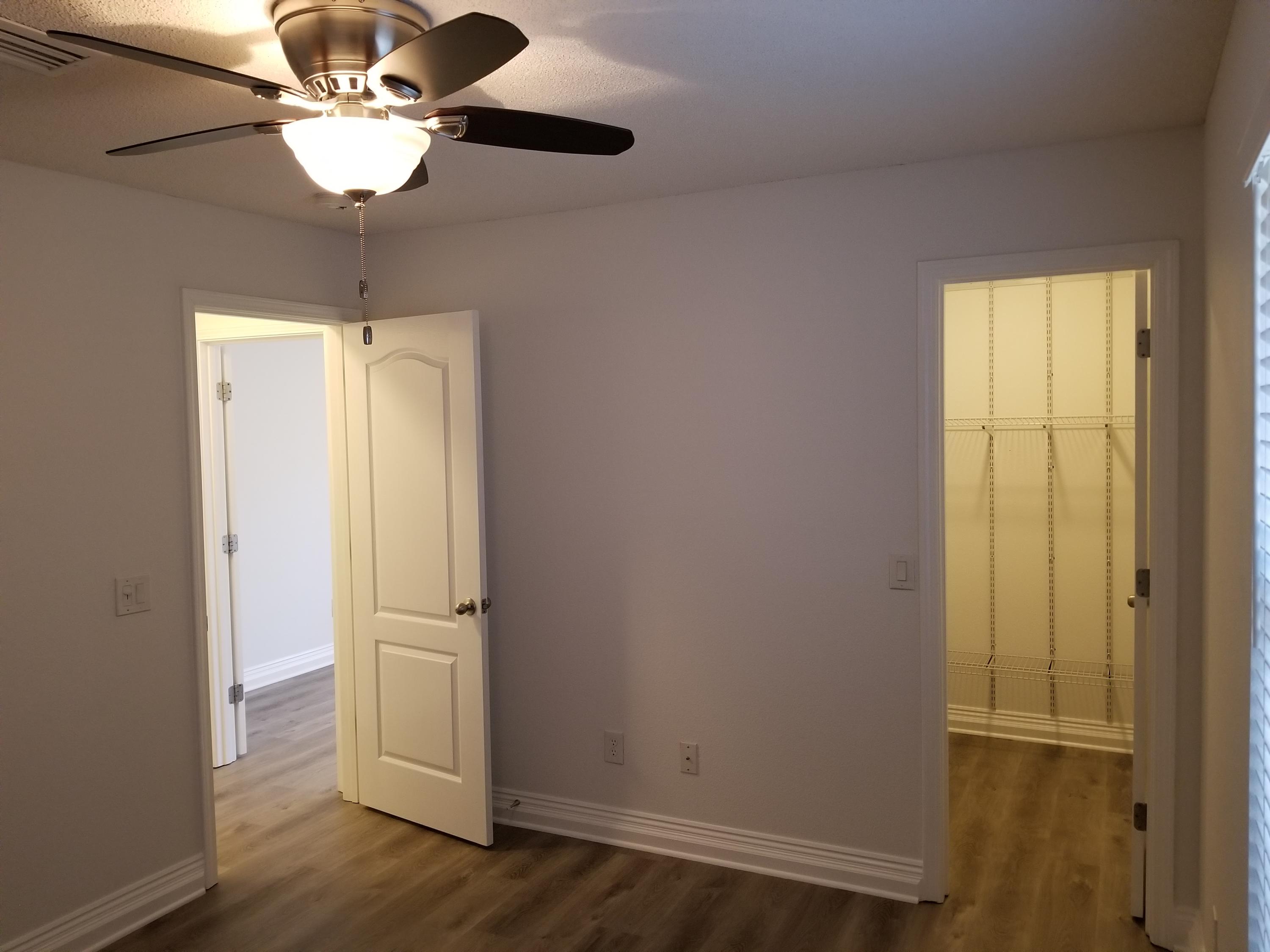 6673 Redfield Street Navarre, FL 32566 - Photo 24 of 32 a view of an empty room with wooden floor