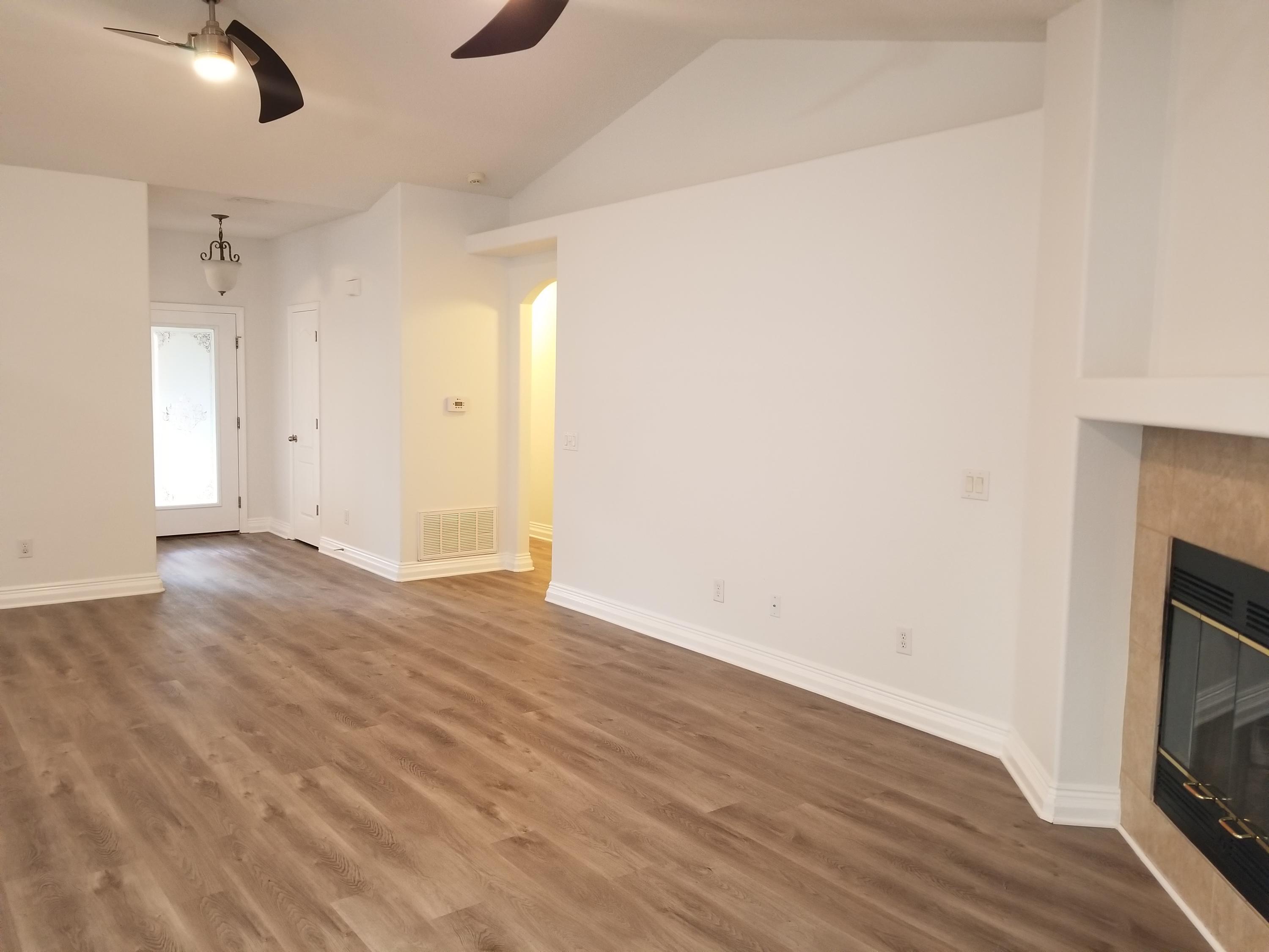 6673 Redfield Street Navarre, FL 32566 - Photo 10 of 32 a view of empty room with wooden floor