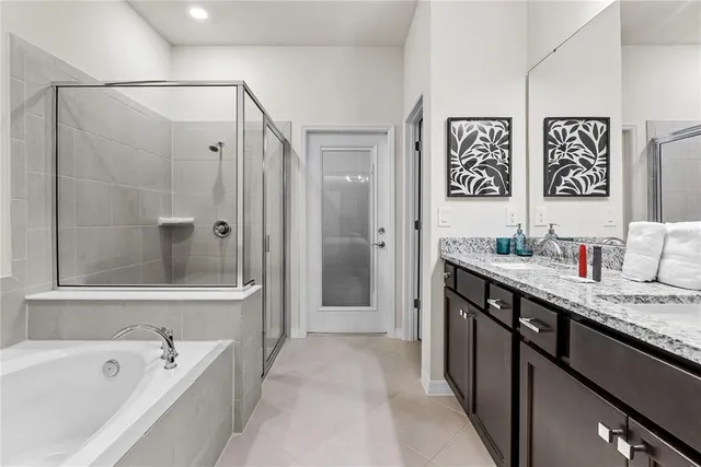 a bathroom with a granite countertop sink mirror shower and double