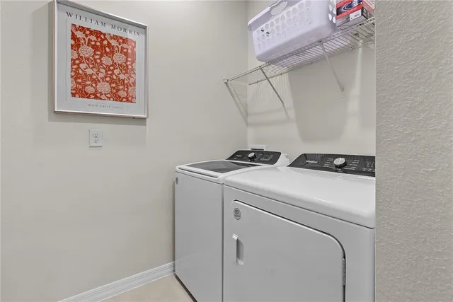 a bedroom with a bed and painting on the wall