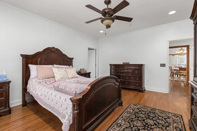 a bedroom with bed and wooden floor