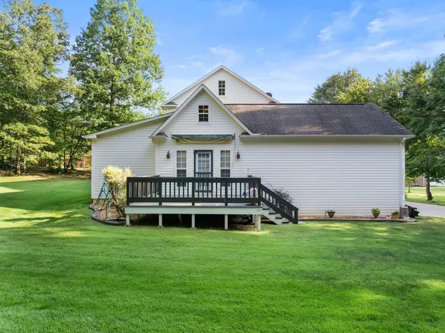 a view of a house with a yard and sitting area