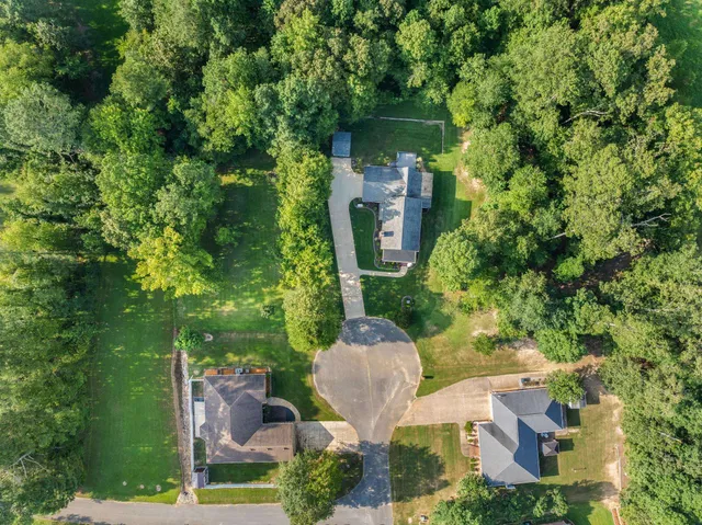an aerial view of a house with outdoor space