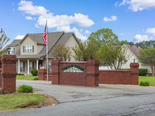 a front view of a house with a garden and mountain view