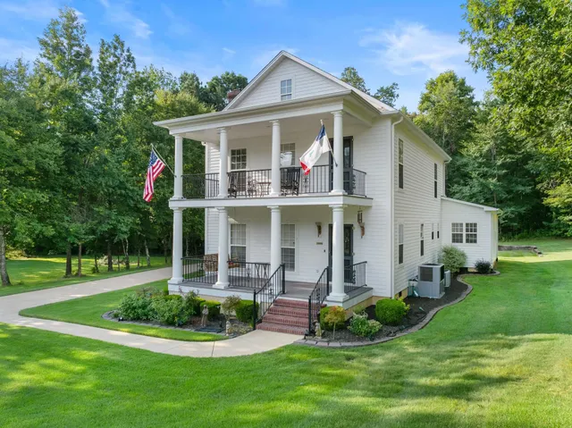 a front view of a house with a yard table and chairs