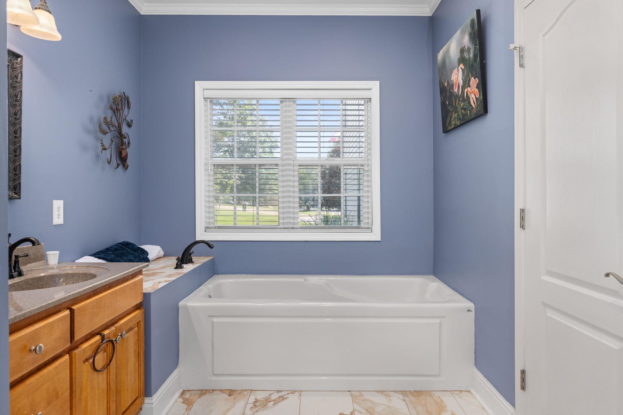 20 Tadpole Lane Corinth, MS 38834 - Photo 5 of 38 Full bath featuring a garden tub, ornamental molding, vanity, and marble finish flooring