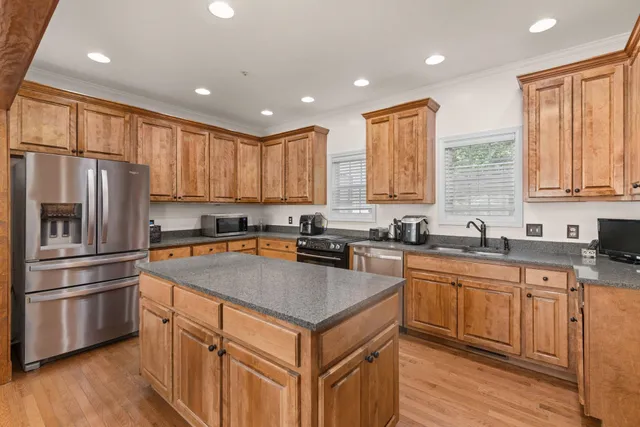 a kitchen with a refrigerator sink and cabinets