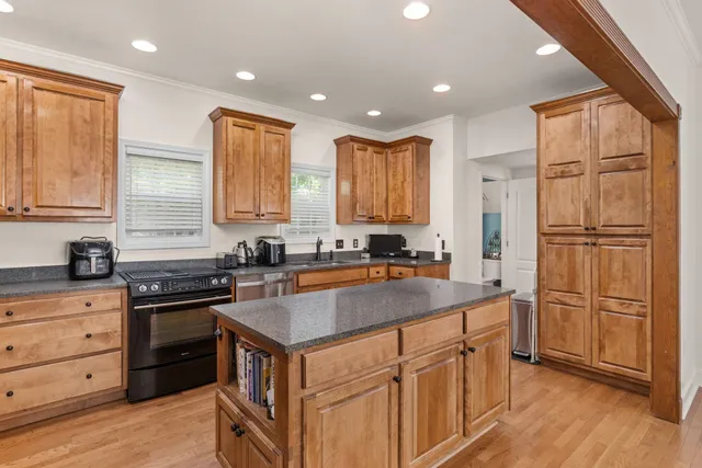 a kitchen with stainless steel appliances granite countertop a sink stove and refrigerator