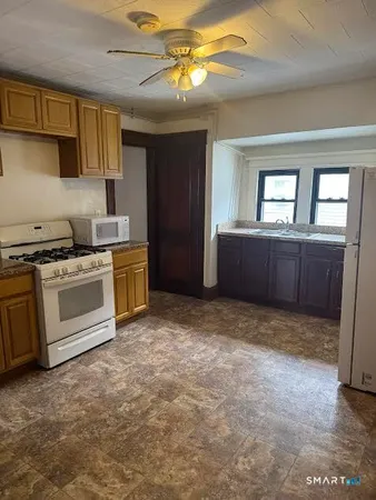 a kitchen with a stove a sink and a refrigerator