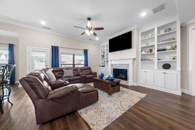a living room with furniture fireplace and flat screen tv