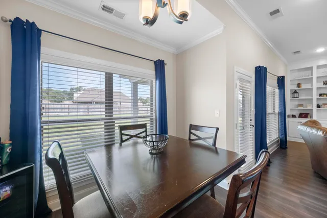 a view of a dining room with furniture and window