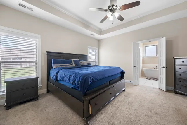 a bedroom with a bed and a chandelier