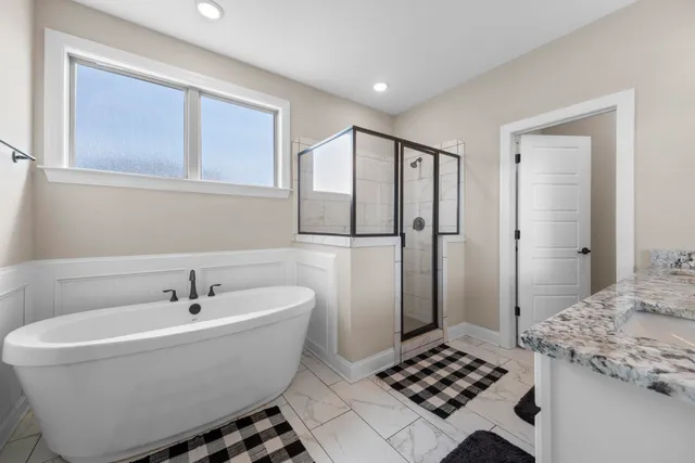 a bathroom with a bathtub and shower