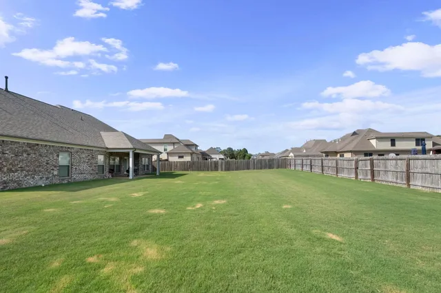 a view of a house with a big yard and a big yard
