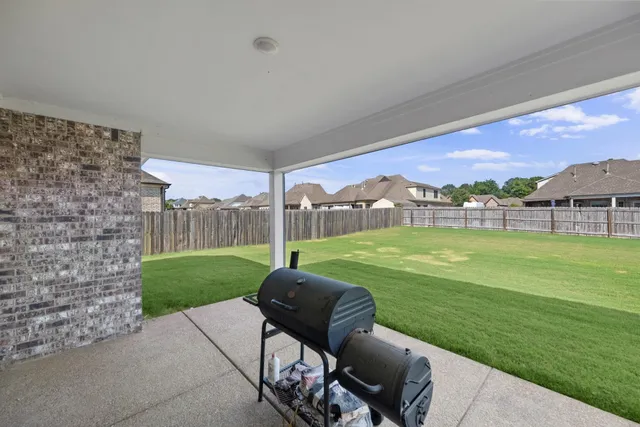 a view of a two chairs in the backyard