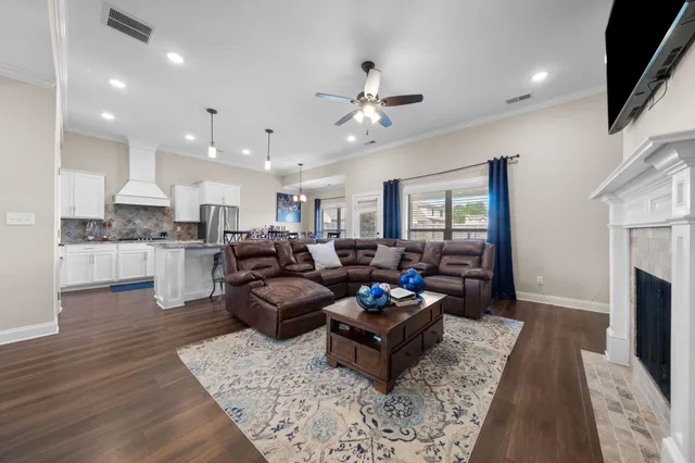 a living room with fireplace furniture and a flat screen tv