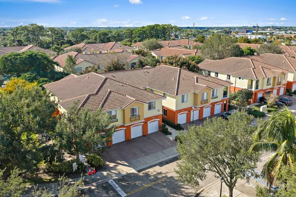 an aerial view of residential houses with outdoor space and street view