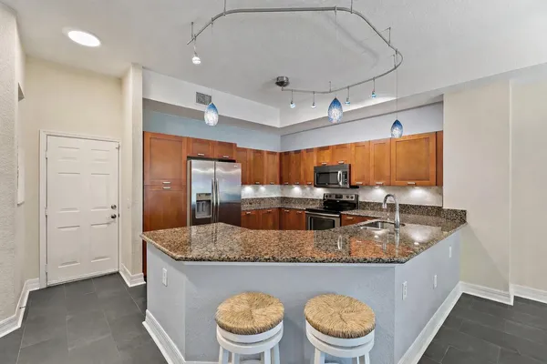 a kitchen with stainless steel appliances a stove sink microwave and cabinets