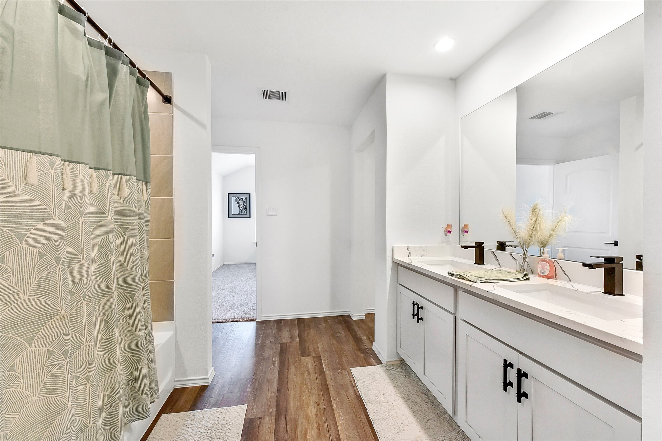 24222 Sandstone Valley Ln Spring Spring, TX 77373 - Photo 20 of 32 a view of a bathroom with a sink and mirror