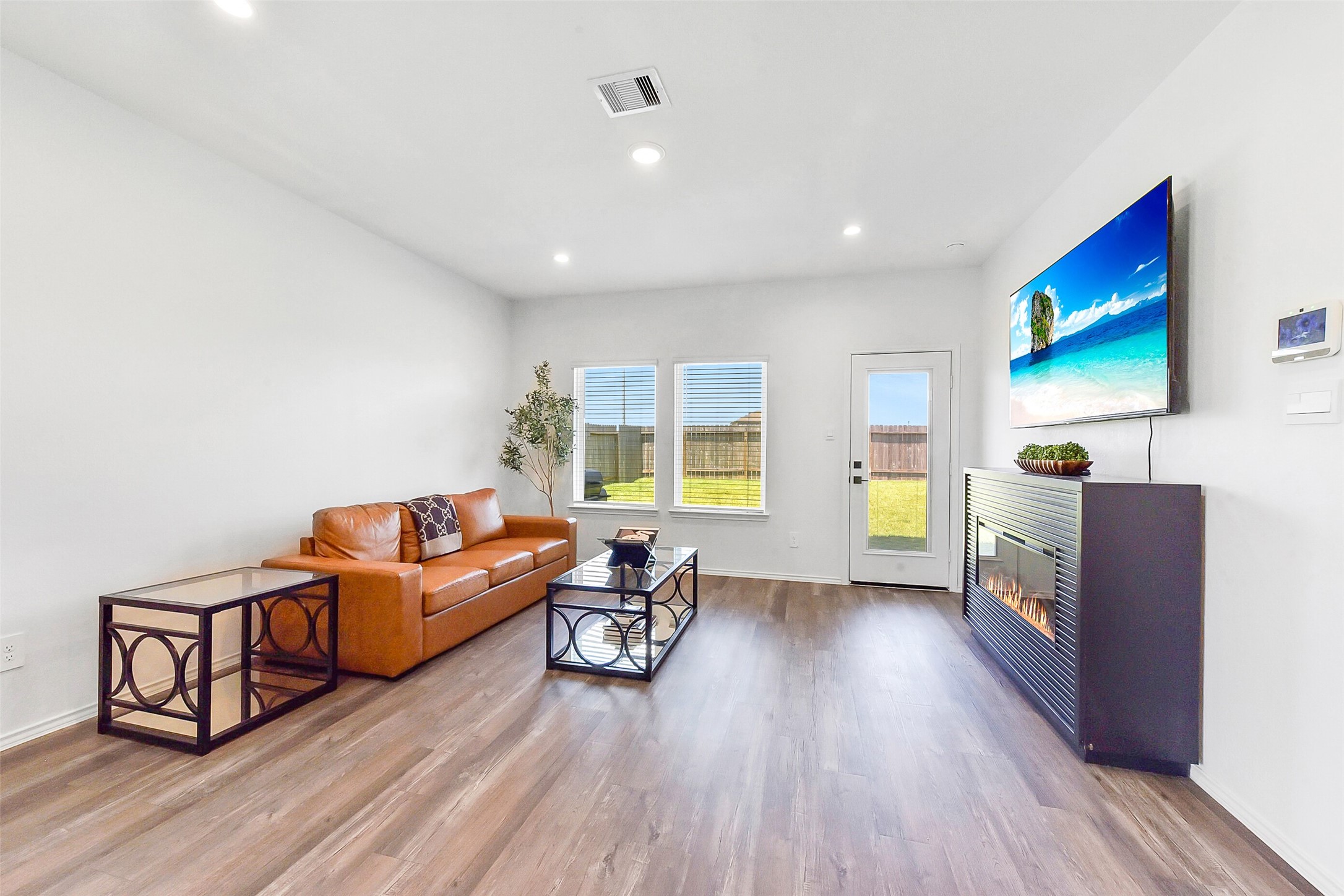 24222 Sandstone Valley Ln Spring Spring, TX 77373 - Photo 6 of 32 a living room with furniture and a flat screen tv