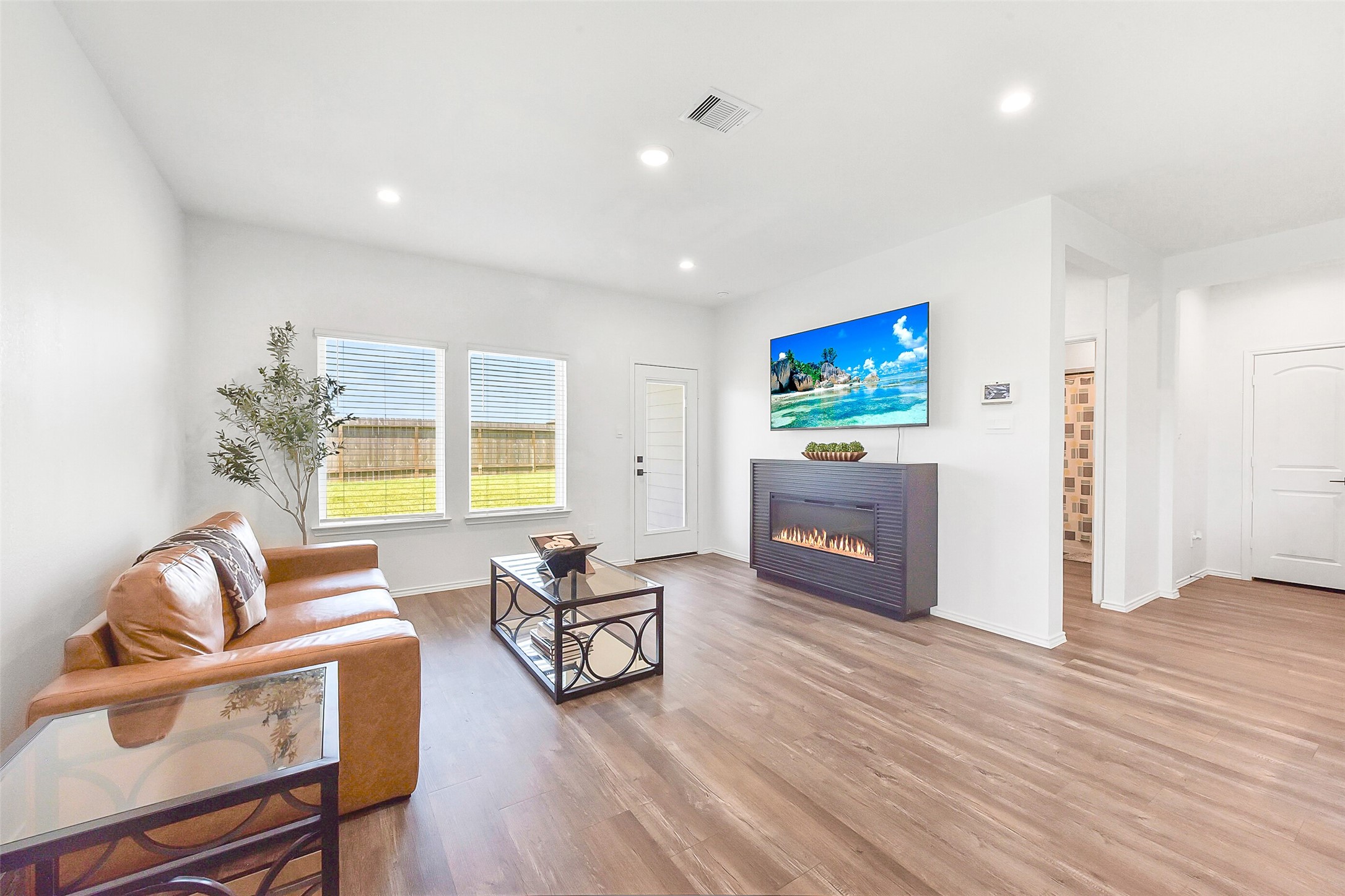 24222 Sandstone Valley Ln Spring Spring, TX 77373 - Photo 7 of 32 a living room with furniture and a flat screen tv