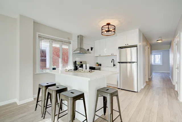 a kitchen with stainless steel appliances a refrigerator and a stove top oven