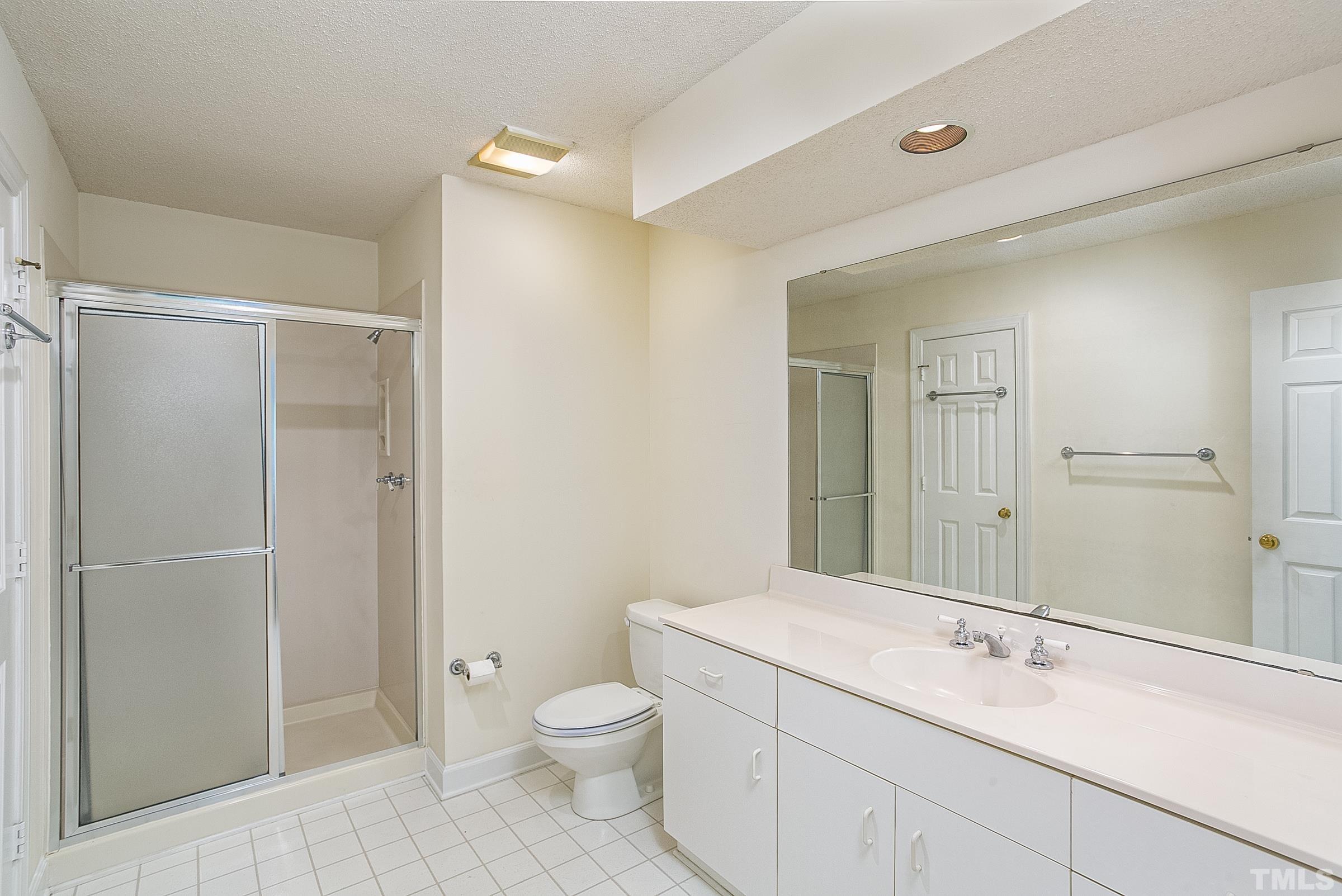 547 Weathersfield Pittsboro, NC 27312 - Photo 19 of 37 a bathroom with a shower sink vanity mirror and toilet