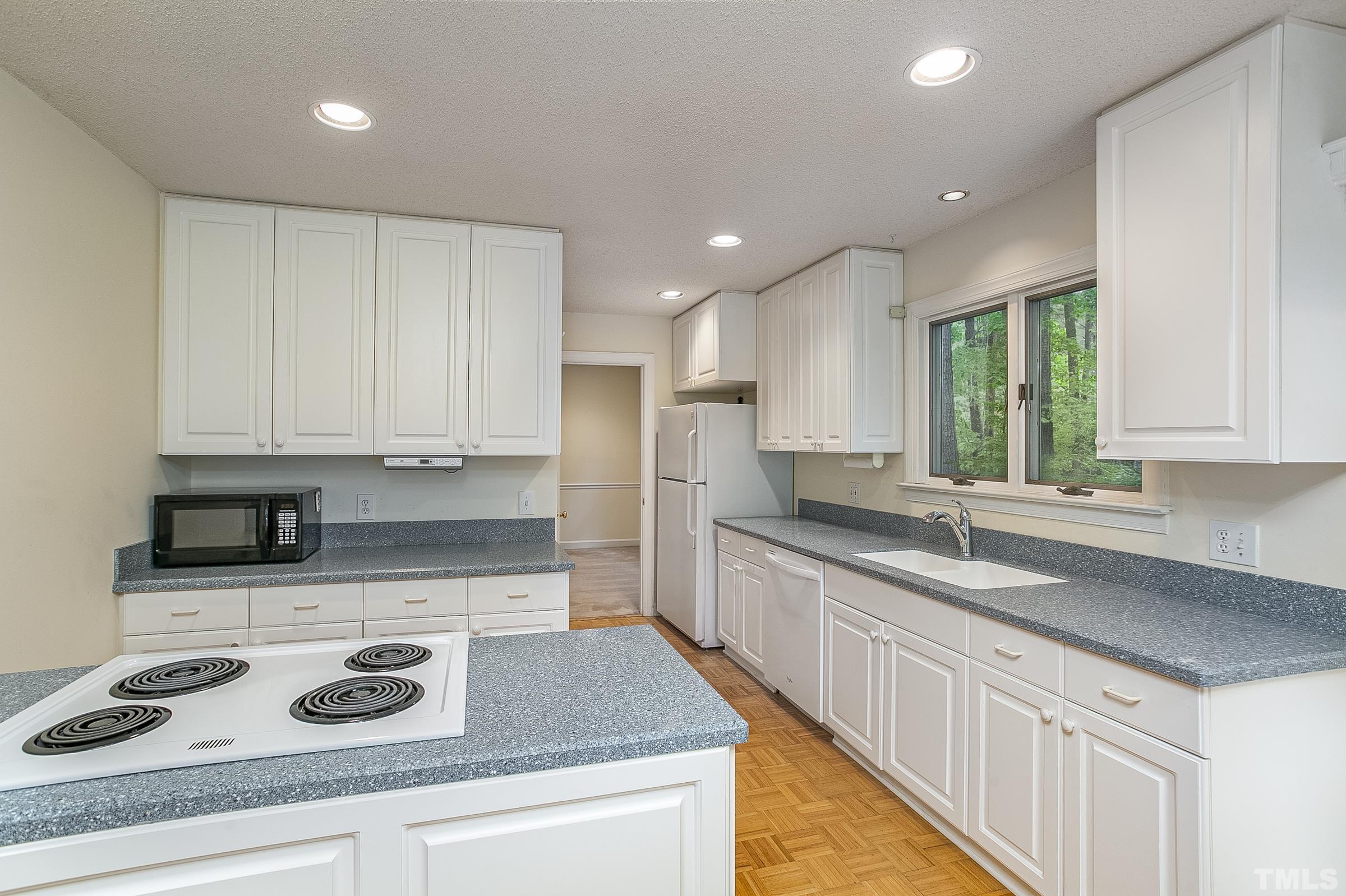547 Weathersfield Pittsboro, NC 27312 - Photo 5 of 37 a kitchen with granite countertop kitchen island stainless steel appliances a sink stove and cabinets