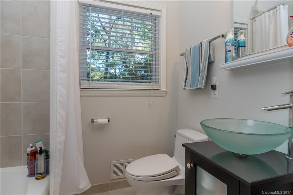4749 Gaynor Road Charlotte, NC 28211 - Photo 14 of 24 a bathroom with a toilet a sink and a window