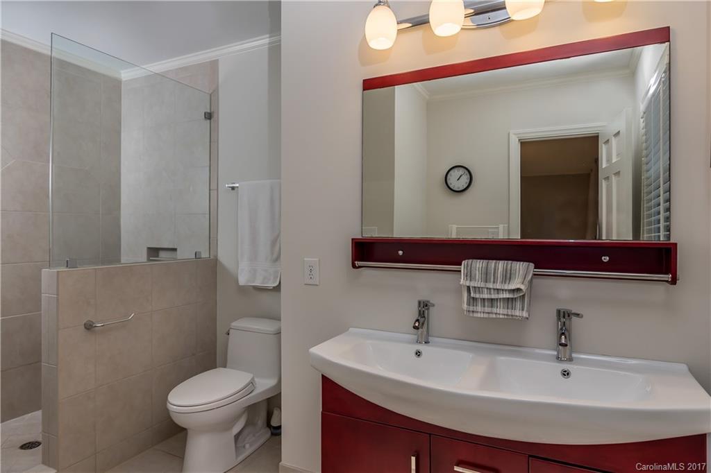 4749 Gaynor Road Charlotte, NC 28211 - Photo 16 of 24 a bathroom with a sink a toilet and mirror