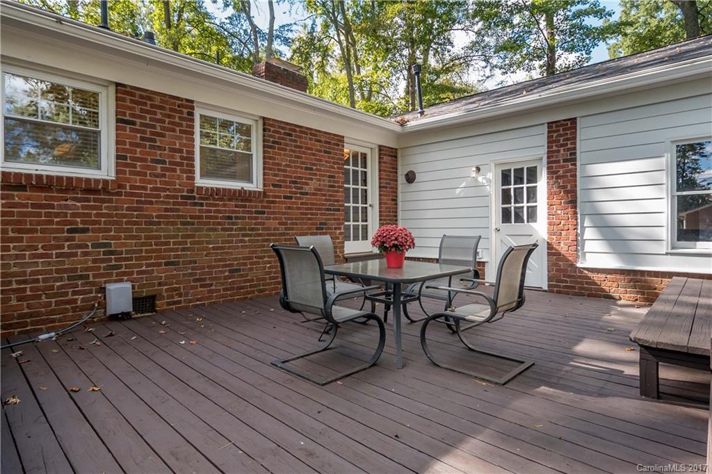4749 Gaynor Road Charlotte, NC 28211 - Photo 20 of 24 a view of a patio with table and chairs with wooden floor and fence