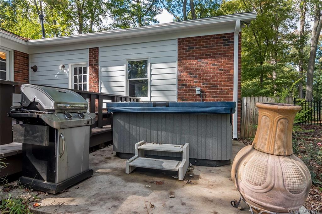 4749 Gaynor Road Charlotte, NC 28211 - Photo 22 of 24 a backyard of a house with barbeque oven fire pit and outdoor seating
