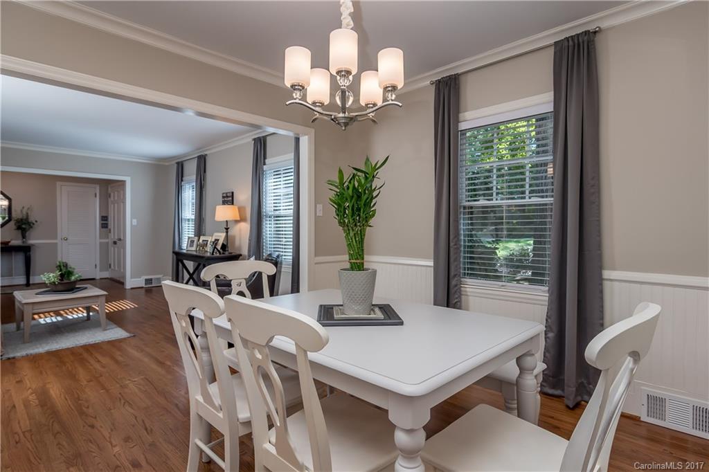 4749 Gaynor Road Charlotte, NC 28211 - Photo 5 of 24 a view of a dining room with furniture a chandelier and wooden floor