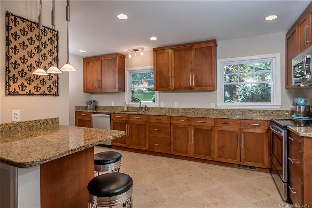 4749 Gaynor Road Charlotte, NC 28211 - Photo 9 of 24 a kitchen with granite countertop a sink and a stove
