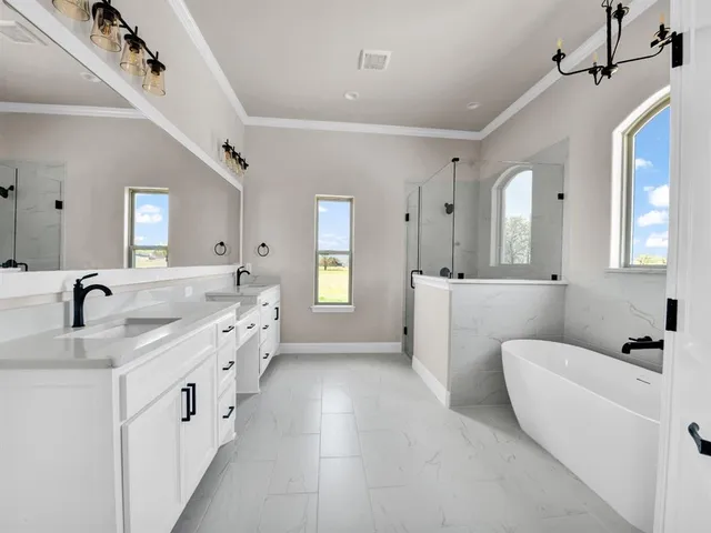 a bathroom with a granite countertop sink a toilet and shower