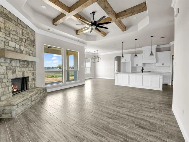 a view of an empty room with a window and a ceiling fan