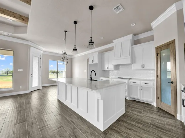 a kitchen with kitchen island white cabinets and white appliances