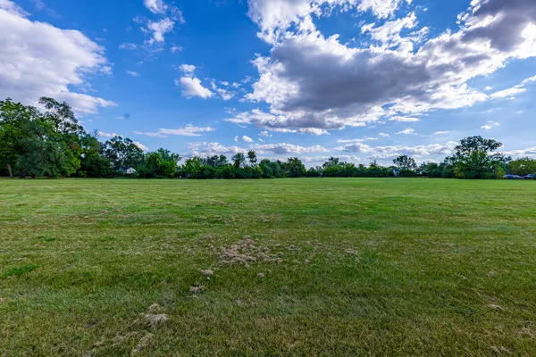 a view of a big yard with lots of green space