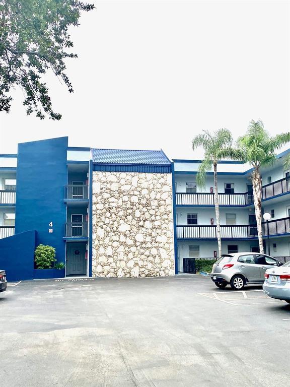 3130 Holiday Springs Boulevard, Unit 104 Margate, FL 33063 - Photo 4 of 7 a car parked in front of a building