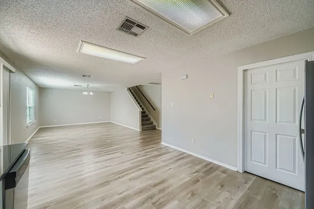 a kitchen with granite countertop a stove a sink and a microwave