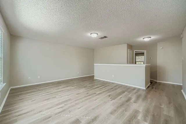 a view of a backyard with a garden and trees