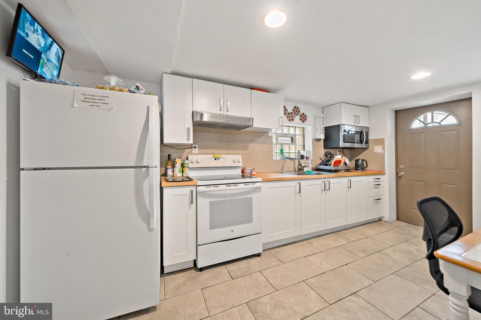 653 North 33rd Street Philadelphia, PA 19104 - Photo 13 of 28 a kitchen with stainless steel appliances a refrigerator sink and cabinets