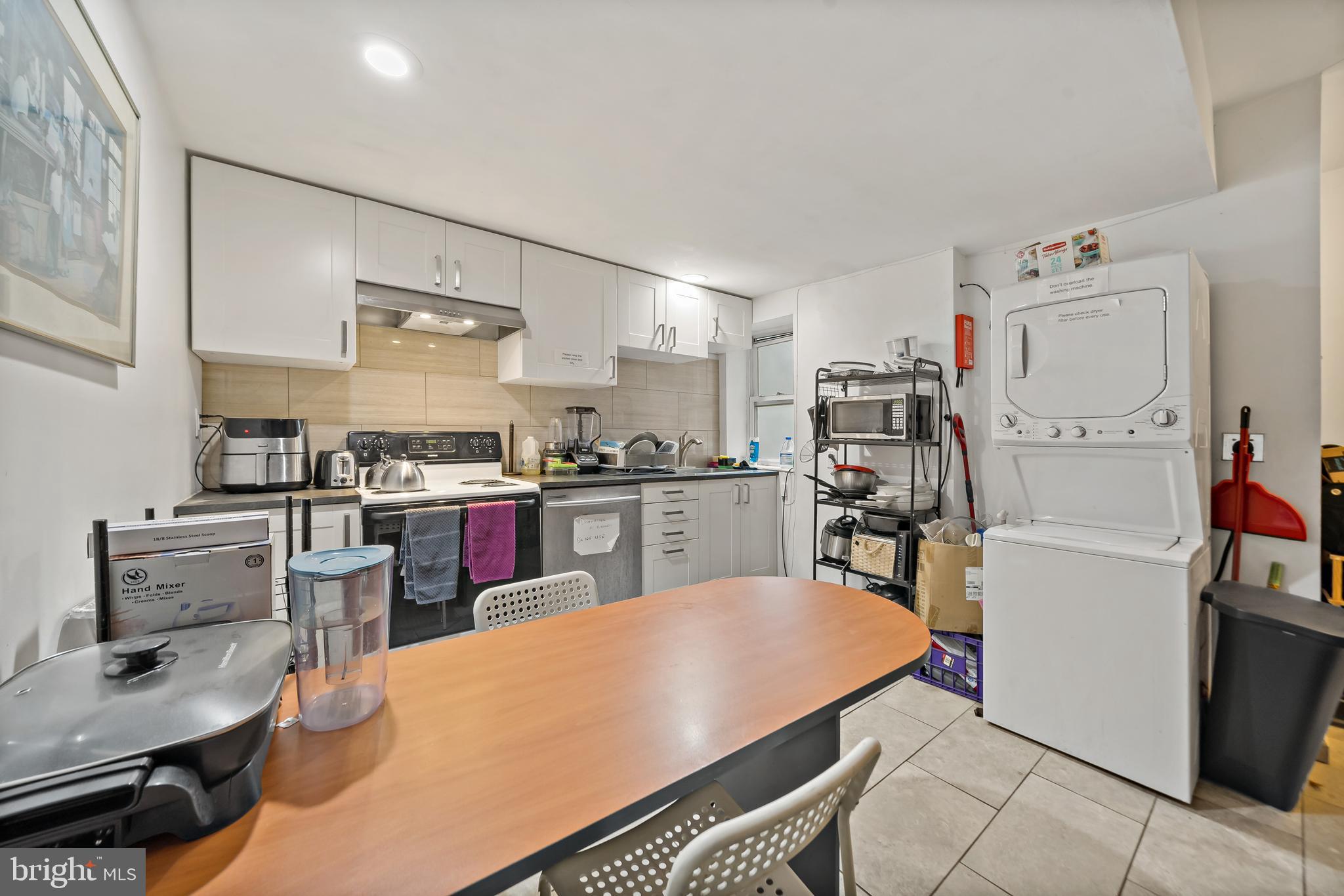 653 North 33rd Street Philadelphia, PA 19104 - Photo 18 of 28 a kitchen with a refrigerator a stove and white cabinets