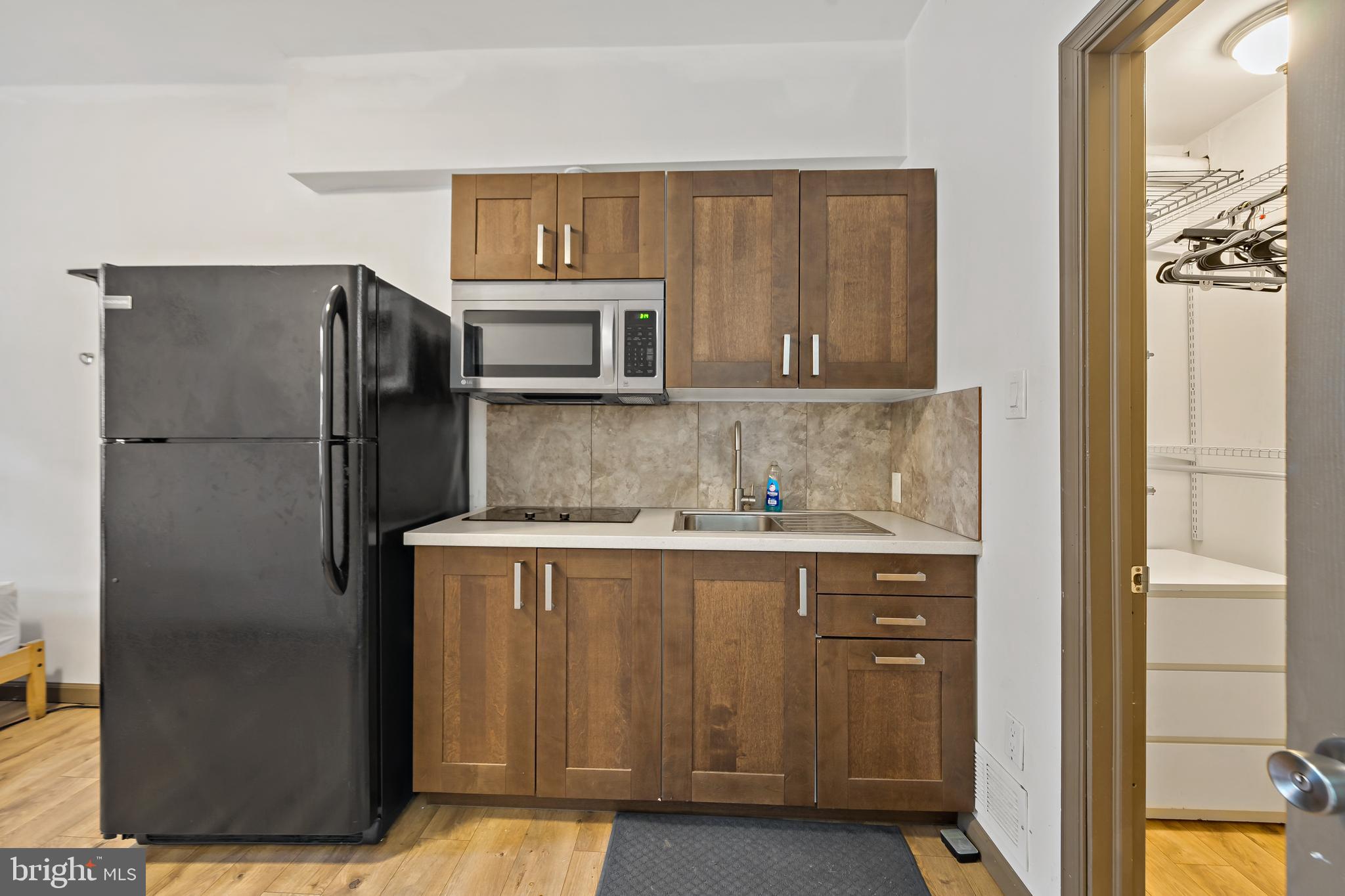 653 North 33rd Street Philadelphia, PA 19104 - Photo 6 of 28 a kitchen with stainless steel appliances granite countertop a refrigerator and a stove