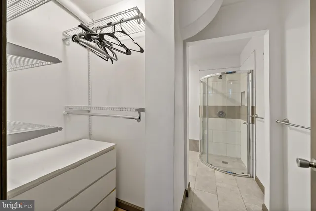 a bathroom with a shower and a sink