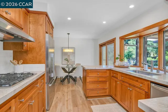 a kitchen with stainless steel appliances granite countertop a stove and a sink