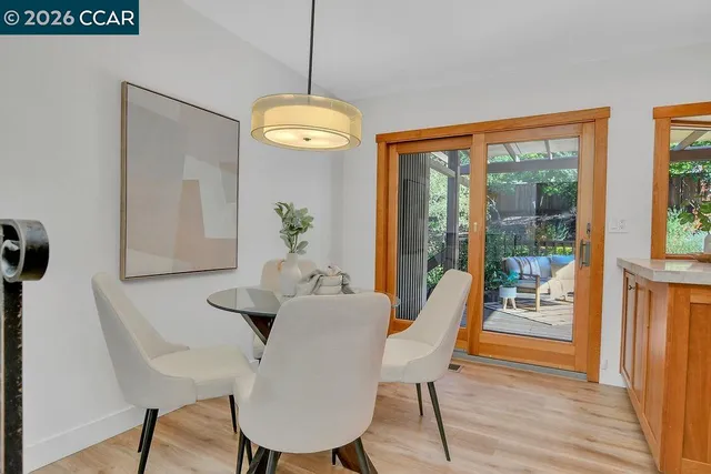a view of a dining room with furniture wooden floor and chandelier