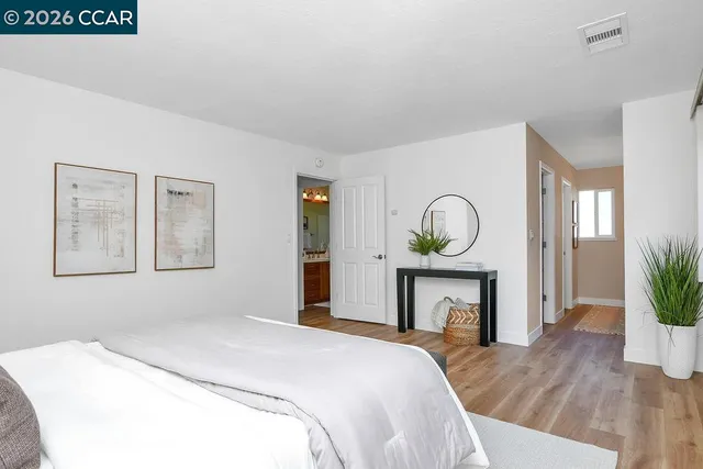 a bedroom with a bed and a fireplace