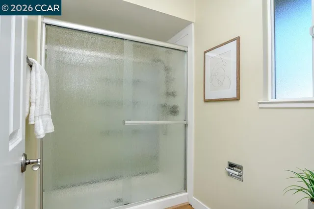 a bathroom with a glass shower door