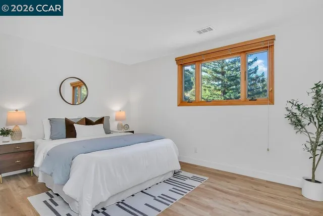 a bedroom with a bed and a potted plant